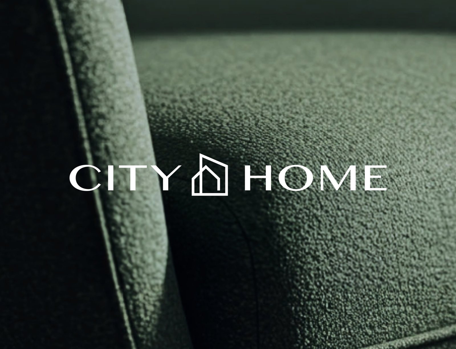 CITY HOME wordmark over green boucle upholstery